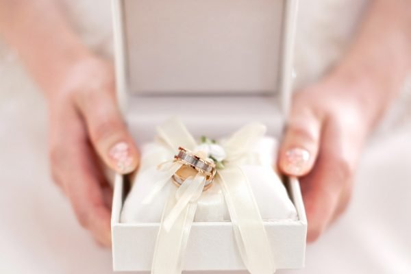 close-up-female-hand-holding-wedding-rings-box.jpg